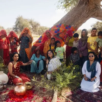 Alt text: taken for Fearless Foundation for the Arts, a group of people in traditional clothing posing in front of a tree. Image credit: Fabrice Bourgelle.